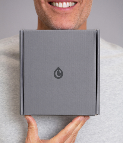 Man smiling while holding a Colorsmith box.
