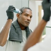 Man applying Colorsmith Custom Color to blend gray hair